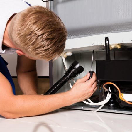 Technician Checking Refrigerator — Appliances in Mareeba, QLD